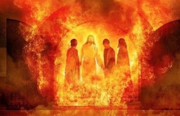 Four people standing in front of a fiery, glowing background with a large, bright circle behind them. The scene has a dramatic, intense atmosphere.