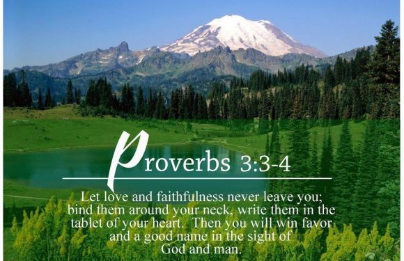 A scenic landscape with snow-capped mountains, lush green forest, and a tranquil lake under a clear blue sky.