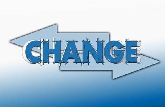 A 3D arrow-shaped sign with the word "CHANGE" in large blue letters, pointing to the right, set against a white and blue background.