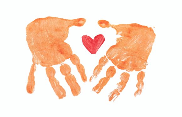 Two orange handprints with fingers pointing downward, a red heart between them, on a white background.