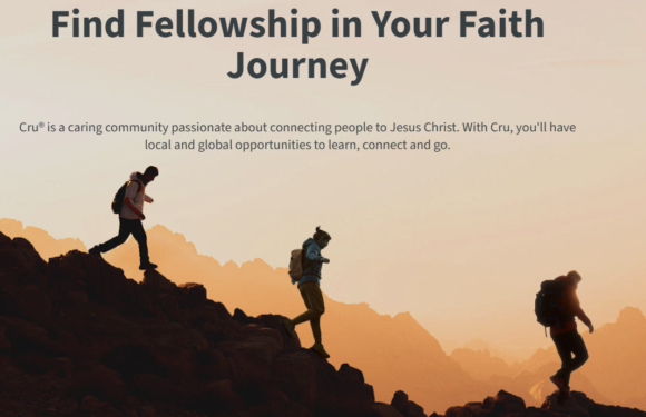 Three hikers with backpacks ascending rocky terrain during sunset or sunrise, with mountains in the background, and a sky with warm tones.