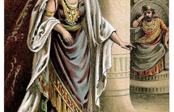 Esther stands inside the king's inner court, dressed in ornate attire with a white shawl, leaning slightly on a pillar, with a woman in a yellow and gray uniform saluting in the background.