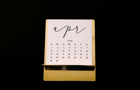 A desk calendar showing April 2018 with a gold base, set against a black background. The calendar has a handwritten-style "apr" at the top.