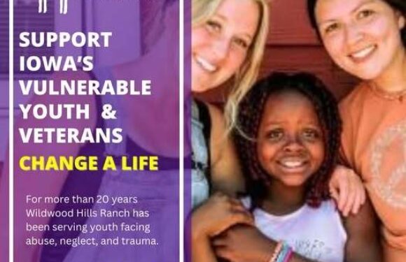 Three smiling young women and a girl with curly hair pose together in front of a red wooden background at a Wildwood Hills Ranch event supporting vulnerable youth and veterans.