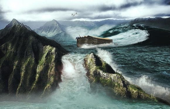 A rocky coastline with moss-covered cliffs, large ocean waves crashing, and a shipwrecked boat near jagged rocks under cloudy skies. Seagulls fly overhead.