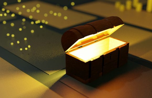 A glowing treasure chest with an open lid, situated on a patterned surface with scattered yellow pieces in the background.