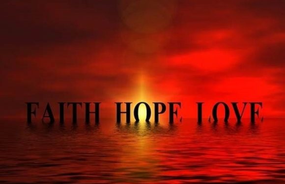 A sunset over water with a fiery red sky, displaying the words "FAITH HOPE LOVE" in large black letters across the scene.