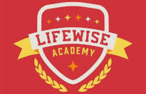 Lifewise Academy shield logo with a red background, white shield, yellow banner, and laurel wreath, featuring stars and the text "Lifewise Academy."