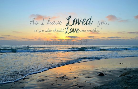 Sunset over the ocean with clouds and waves, featuring a quote from John 13:34 about love and caring for one another.