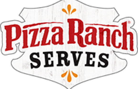 A person in a red uniform with white apron and matching hat, serving food behind a counter at Pizza Ranch restaurant.