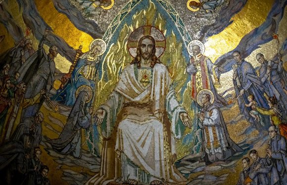 A detailed mosaic depicting Jesus Christ seated on a throne, surrounded by saints and angels, with a radiant golden halo and vibrant colors.
