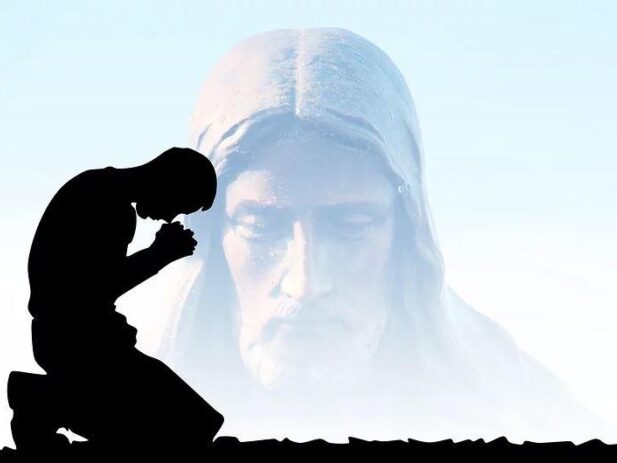 Faded image of Jesus bending down while a person prays