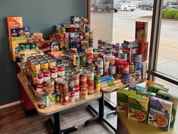 Couples Tables Full of Donated Food items