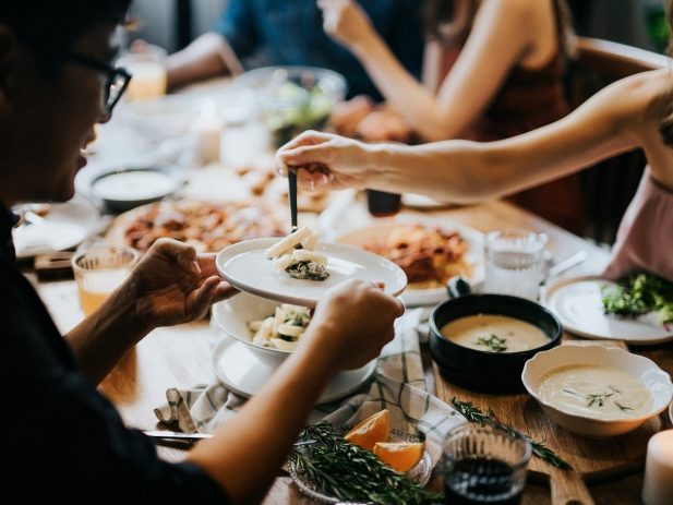 People Gathered around a table, eating together
