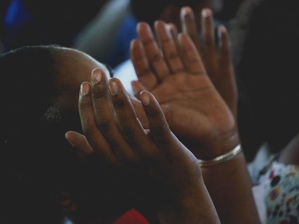 Woman lifting hands in worship