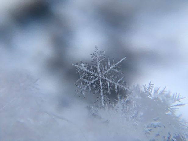 Very close up photo of a snowflake