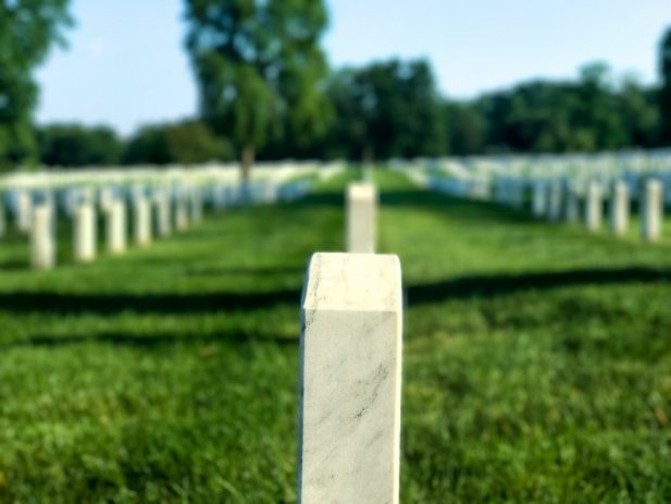 Photo of military headstone in graveyard by Forrest Smith on Unsplash
