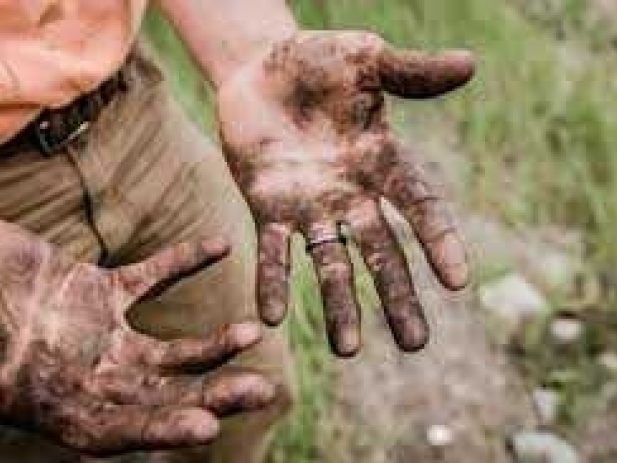 Mud covered hands