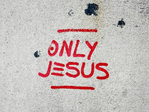Words "Only Jesus" in red letters
