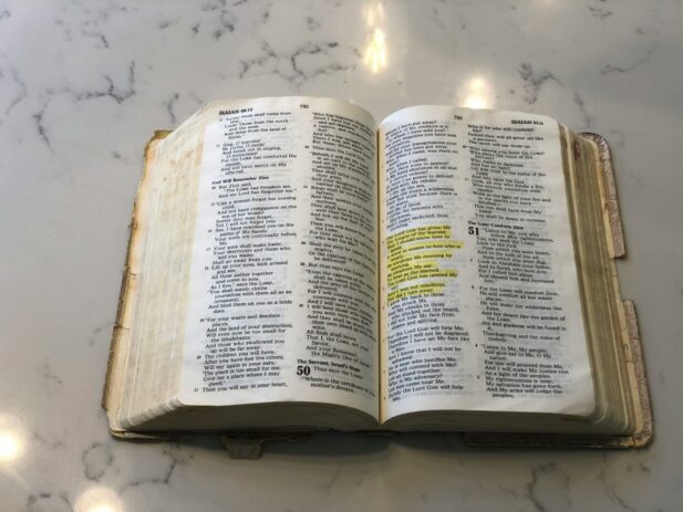 Worn Bible open on counter.