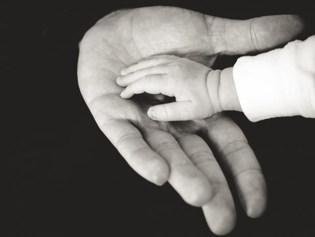 Child hand in hand with dad