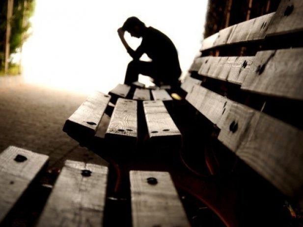 Man sitting alone on a bench