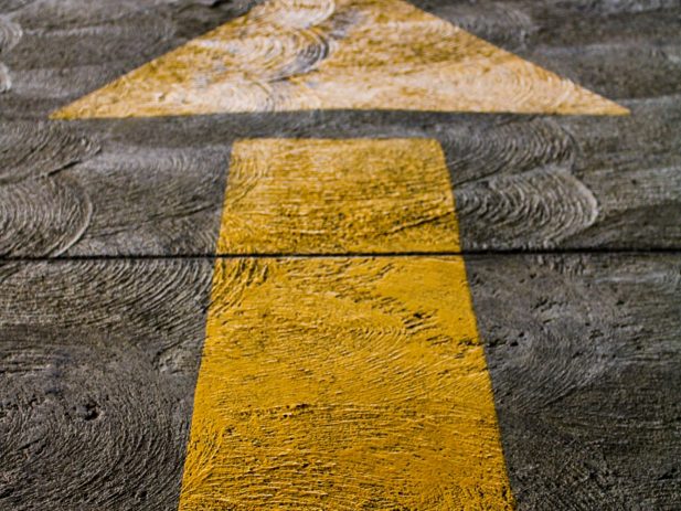 Yellow Directional Arrow on the Road