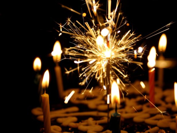 Picture of cake with candles and a sparkler