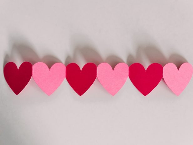 chain of paper hearts on a white background