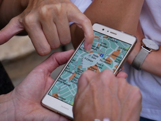 People around a map on a phone