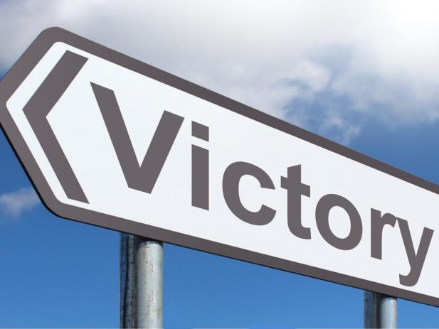 Street sign that says Victory