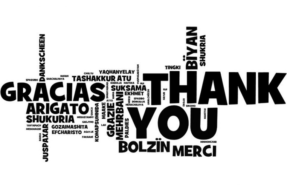 A word cloud with "THANK YOU" in large black letters at the center, surrounded by "GRACIAS," "ARIGATO," "SHUKURIA," and other gratitude expressions in various languages.
