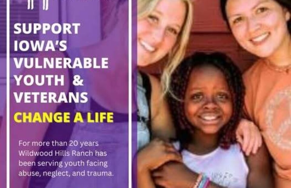 Three smiling young women and a girl with curly hair pose together in front of a red wooden background at a Wildwood Hills Ranch event supporting vulnerable youth and veterans.