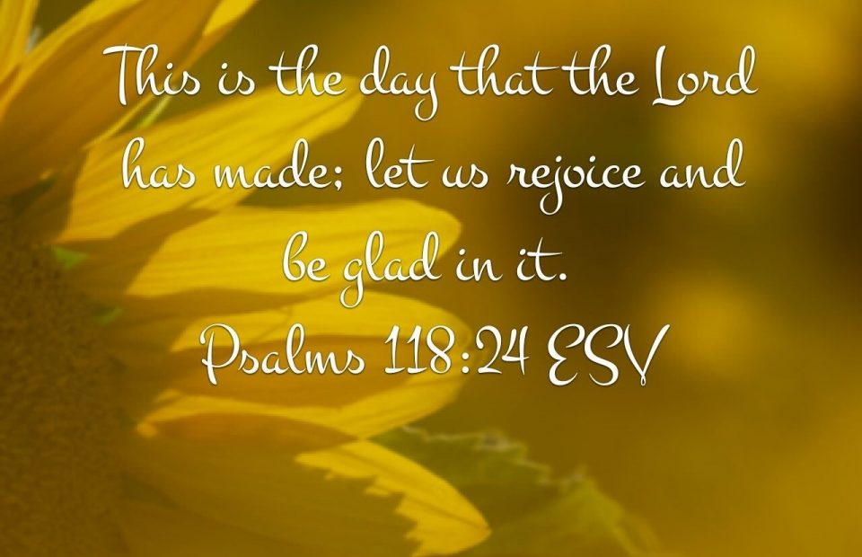 A close-up of yellow flower petals with a quote from Psalms 118:24 ESV overlaid: "This is the day that the Lord has made; let us rejoice and be glad in it."