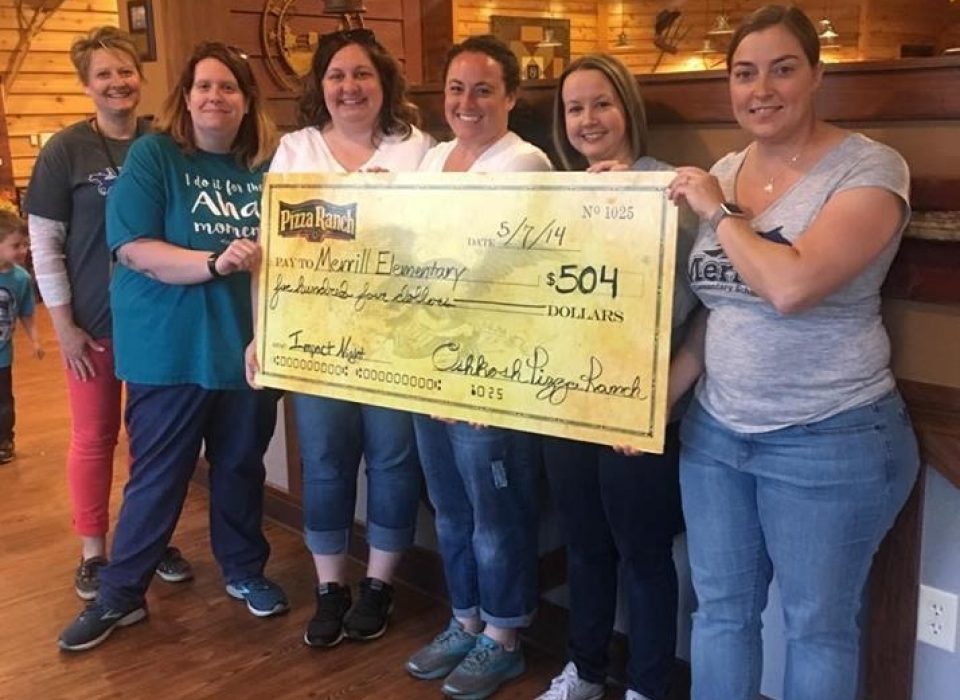 Merrill Elementary School Community Impact Night Group holding their earnings check