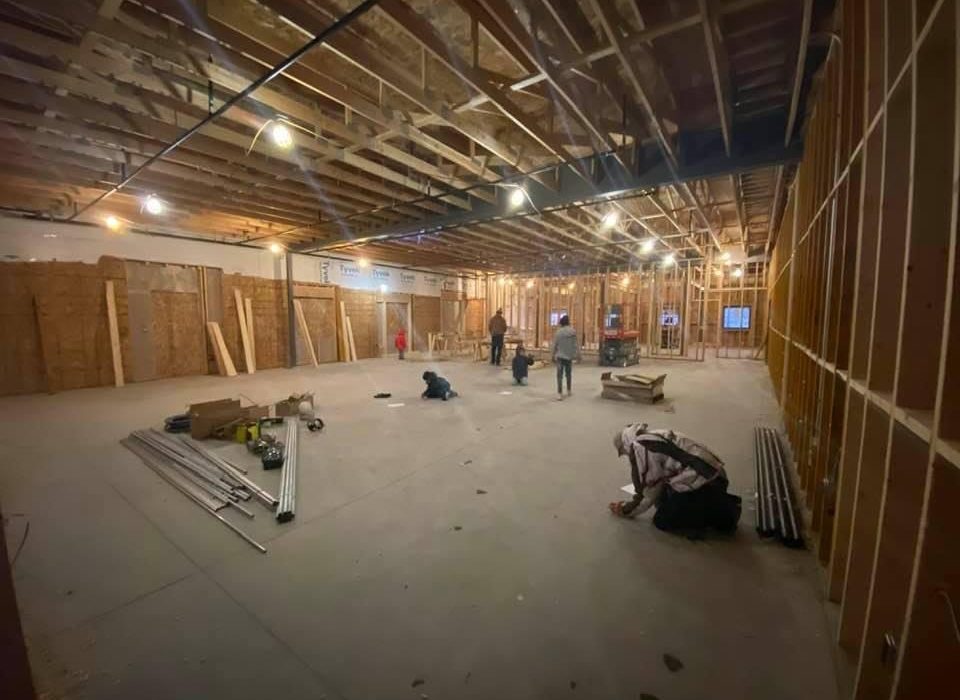 Team members writing bible verses in the addition at the Cedar Rapids Pizza Ranch