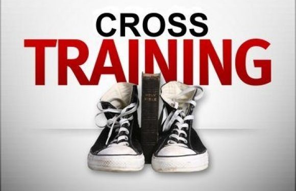 Pair of black and white sneakers with a book in between, and the words "CROSS TRAINING" in bold red and black text on a white background.