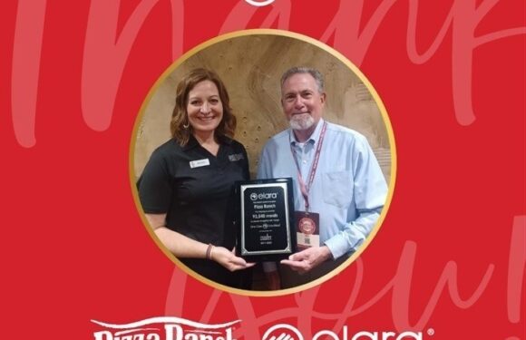 A woman in a black uniform and a man in a light blue shirt hold an award plaque between them, standing in front of a red background with logos for Pizza Ranch, Elara, and "One Case One Meal".
