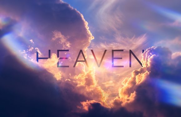 Sunlight breaks through colorful clouds in a sky with the word "HEAVEN" written across it. The scene has a peaceful and divine atmosphere.