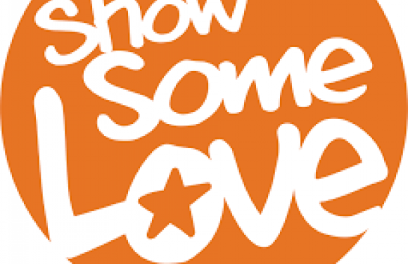 A round orange logo with white text that reads "Show Some Love" and features a star inside the letter "o" in "Love."