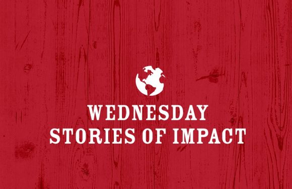 Red wooden background with white Earth icon above the text "Wednesday Stories of Impact" in bold, white letters. A theme of global stories or events.