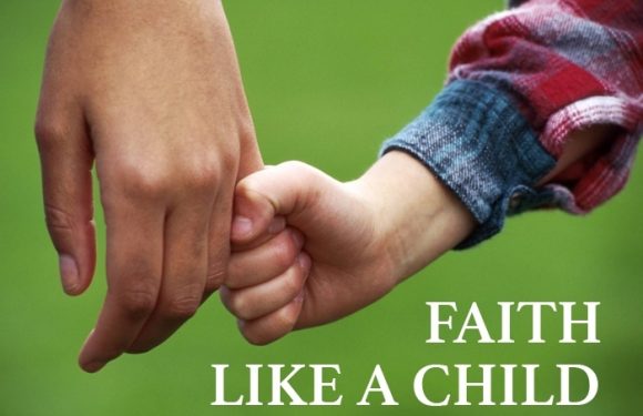 A child’s hand holding an adult’s finger outdoors on a green background, with the text "FAITH LIKE A CHILD" at the bottom.