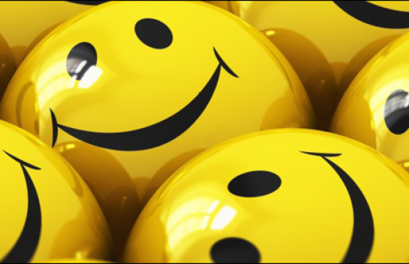 Multiple yellow smiley face balls with black eyes and wide black smiles.
