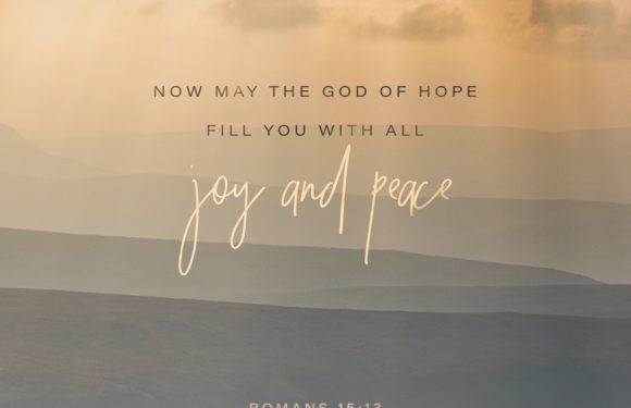A serene landscape with layered rolling hills under a cloudy sky, featuring an inspirational quote about hope, joy, and peace from Romans 15:13.