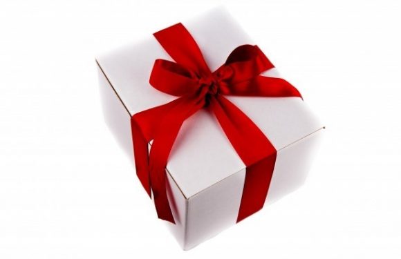 A white gift box wrapped with a red ribbon tied in a bow, set against a white background.