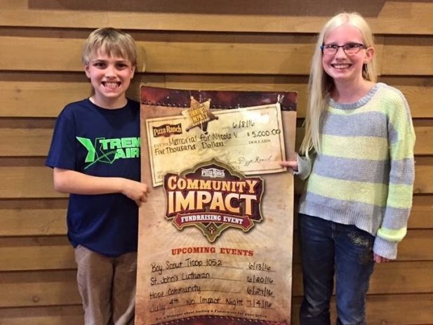 2 of Nicole's kids with their impact day earnings check