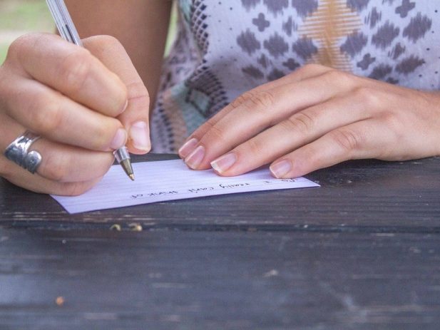 Hand writing a note