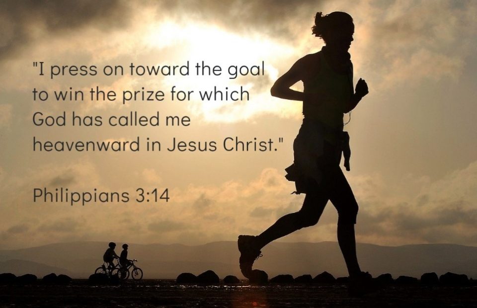 Silhouette of a person running outdoors at sunset, with two children riding bikes in the background and a biblical quote from Philippians 3:14 overlaid.
