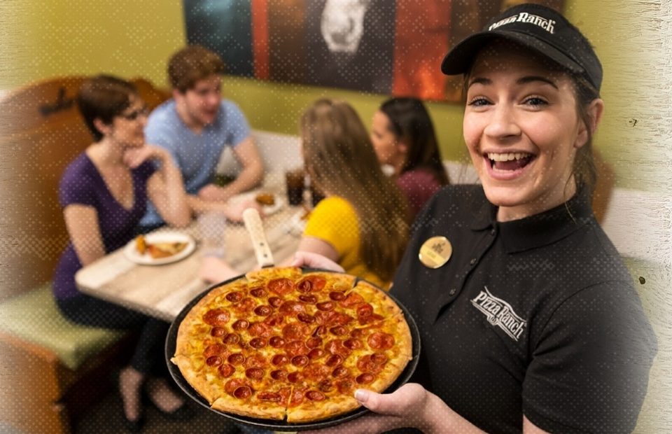 Pizza Ranch employee holding a Pepperoni Pizza