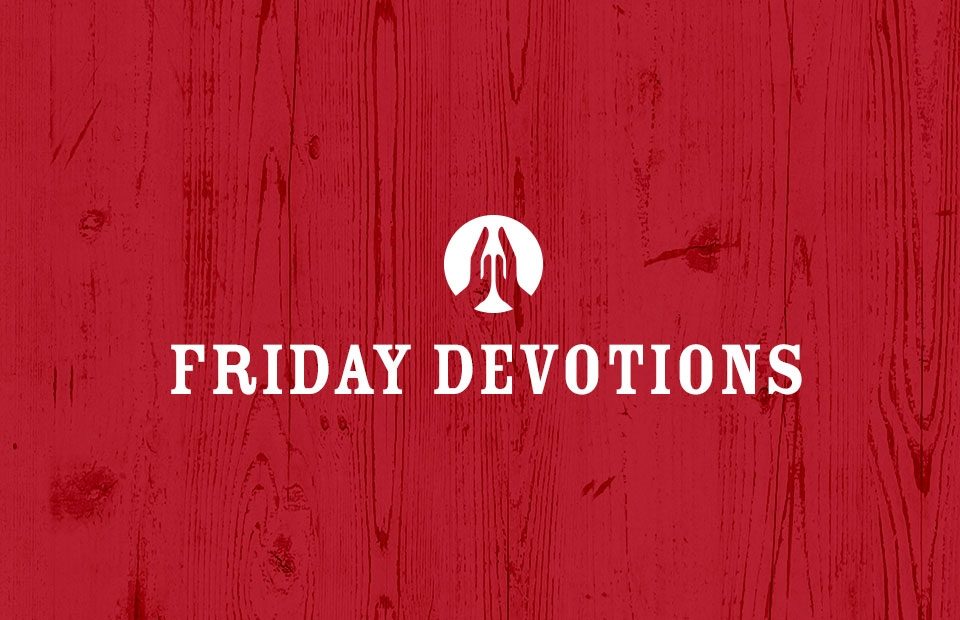 A red wooden background with white text that reads "Friday Devotions" and a white icon of praying hands above the text.
